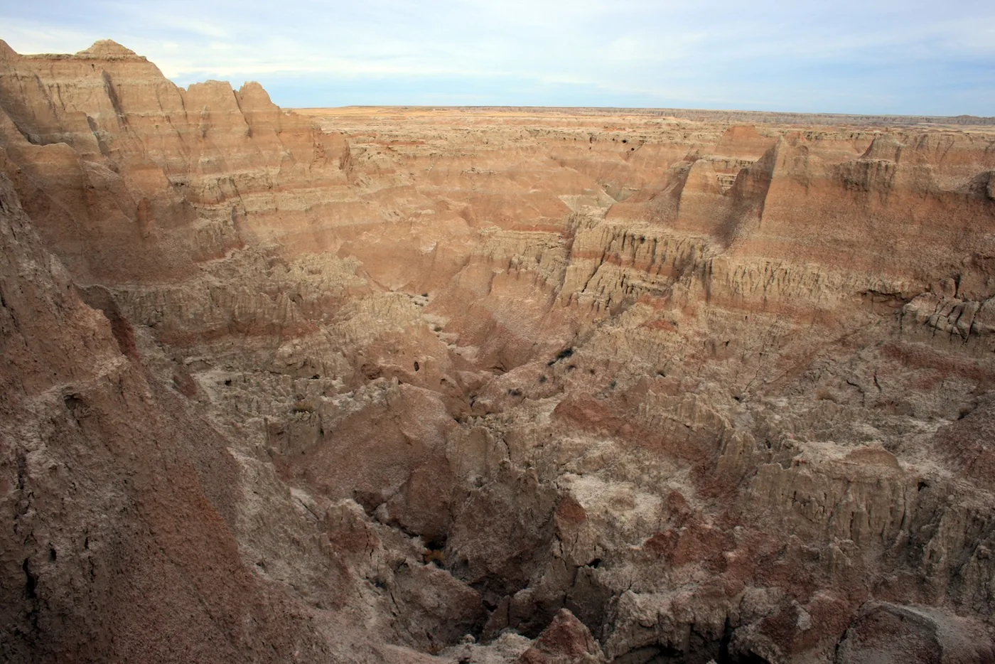 Layered rock formations and rugged peaks in Badlands National Park.
