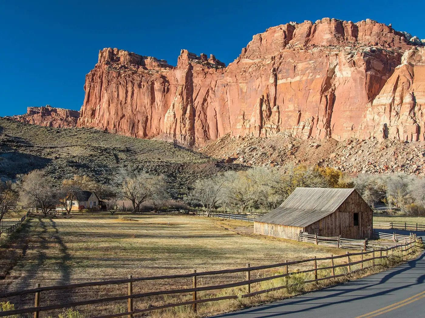 Red sandstone cliffs behind the historic Fruita barn in Capitol Reef National Park.