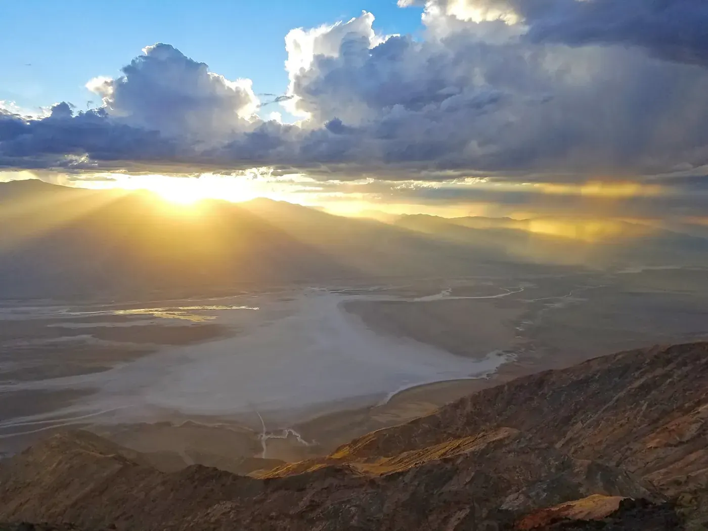 Sunlight breaking through clouds above the salt flats, viewed from Dantes View in Death Valley National Park.