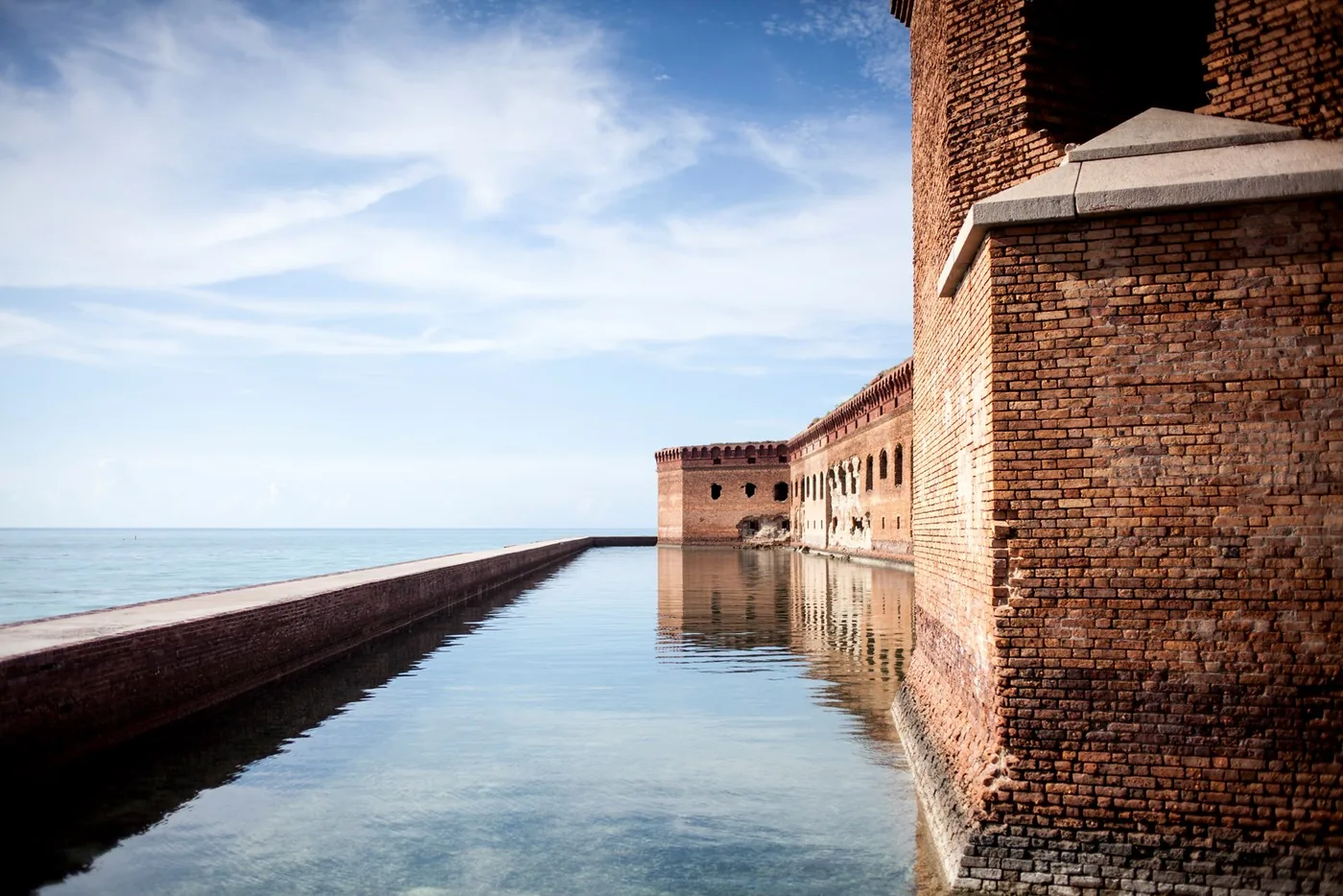 The brick walls and moat of Fort Jefferson beside the sea in Dry Tortugas National Park.