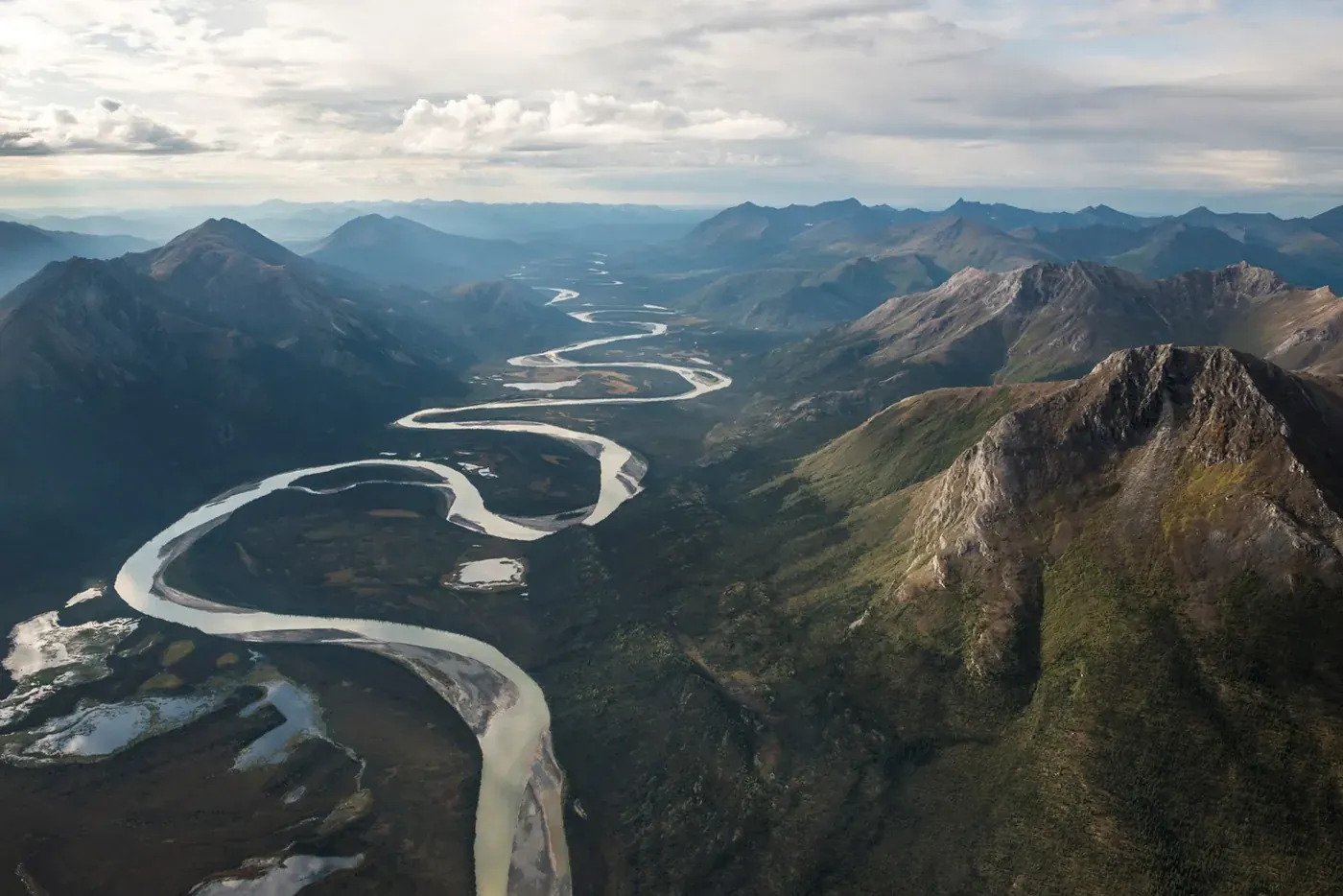 The winding Alatna River between remote mountain ridges in Gates of the Arctic National Park and Preserve.