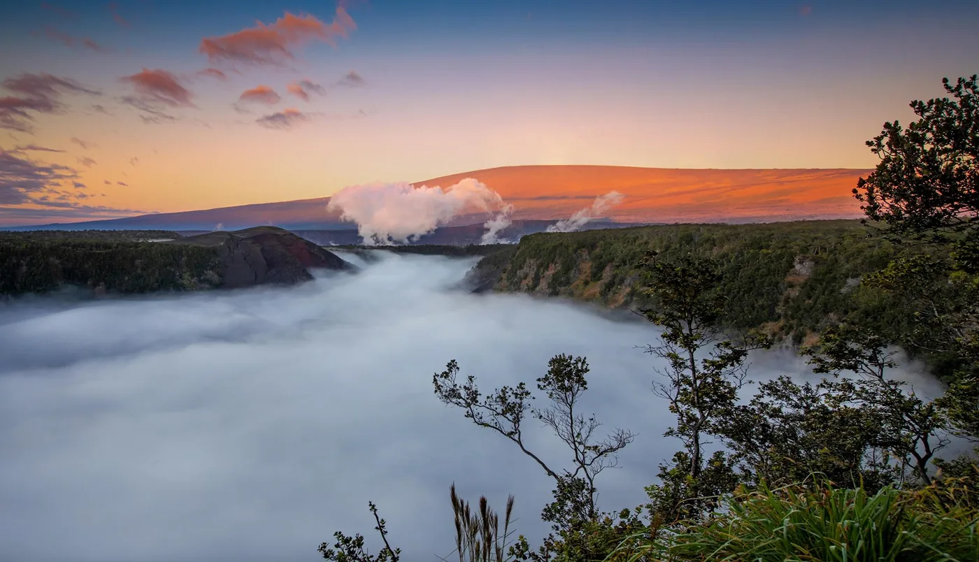 Clouds filling Kilauea Iki crater at sunrise in Hawaii Volcanoes National Park.