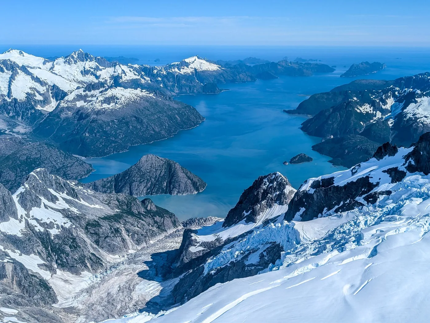 Steep snowy mountains and glacier-carved coastal inlets in Kenai Fjords National Park.