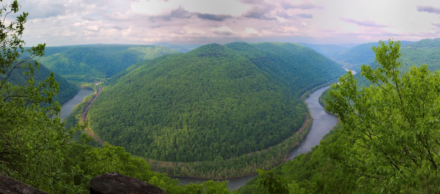 A broad bend in the New River surrounded by green hills, viewed from Grandview.