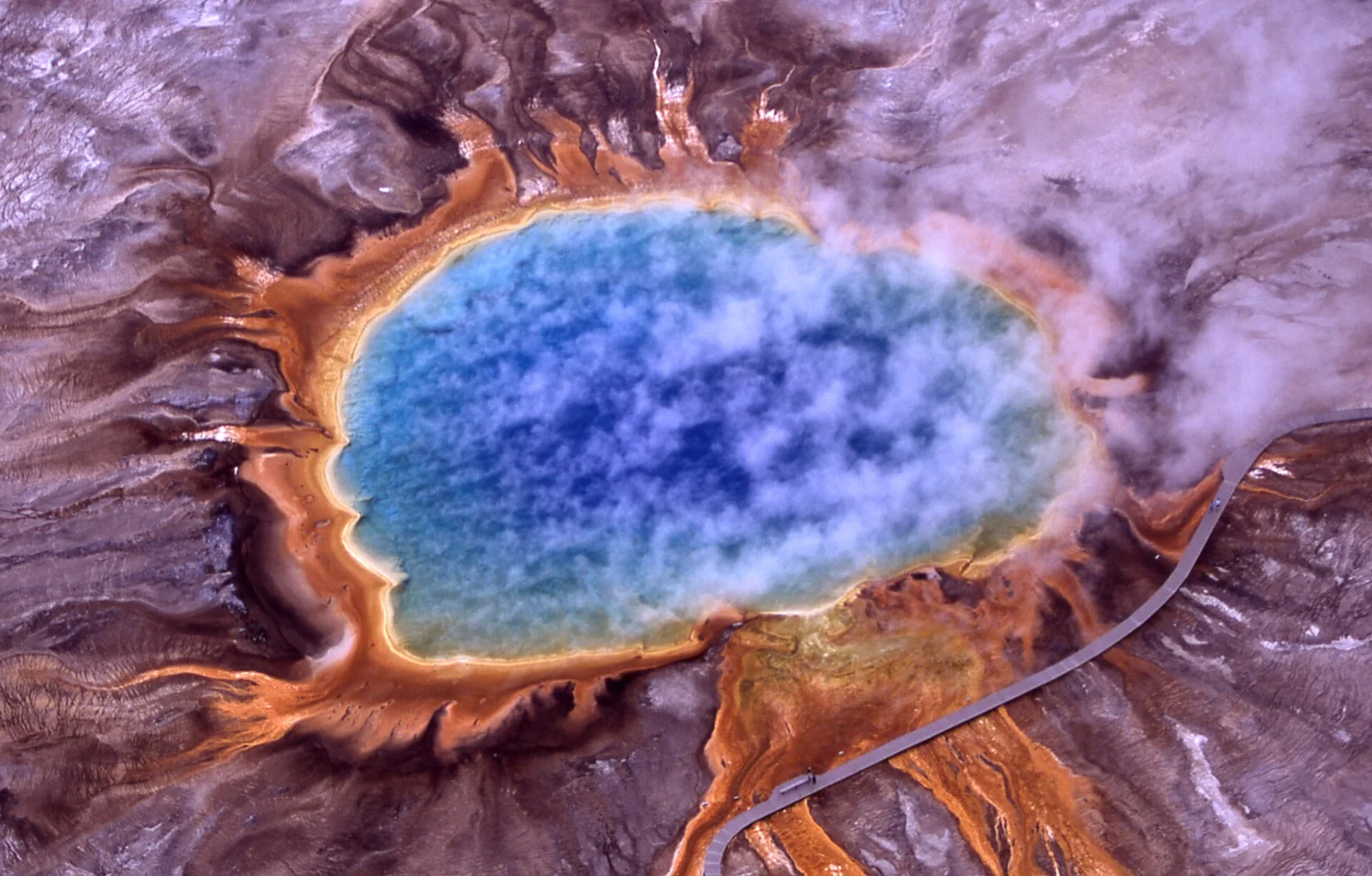 An aerial view of the blue and orange Grand Prismatic Spring in Yellowstone National Park.